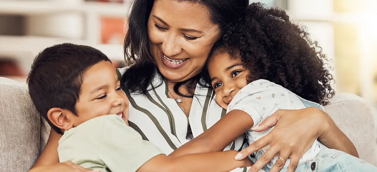 mom hugging kids